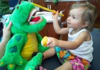 Infant First Visit, with a dinosaur